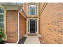 Elegant entryway featuring a black front door with sidelights and transom window at 604 Bassett Se Ct, Smyrna, GA 30080