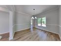 Dining area with hardwood floors, chair railing and a large window with natural light at 6845 Gledhill Way, Stone Mountain, GA 30087