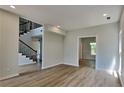 Open concept living space with hardwood flooring and staircase with iron spindles at 6845 Gledhill Way, Stone Mountain, GA 30087