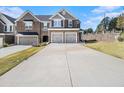 Spacious townhome boasts a two-car garage, ample driveway, and attractive architectural details at 1195 Park Center Cir, Austell, GA 30168