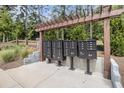 Organized community mailboxes with wooden trellis and decorative concrete accents at 1195 Park Center Cir, Austell, GA 30168