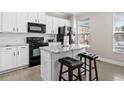 Beautiful kitchen featuring a marble island with seating and stainless-steel appliances at 286 Blue Pointe Ct, Suwanee, GA 30024
