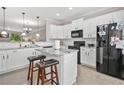 Bright kitchen with white cabinets, granite countertops, and stainless-steel appliances at 286 Blue Pointe Ct, Suwanee, GA 30024