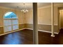 Elegant dining room featuring a chandelier, hardwood floors, and large windows for ample natural light at 3222 Wyndham Park Ct, Decatur, GA 30034