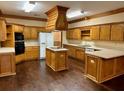 Spacious kitchen with wooden cabinetry, a center island cooktop, and modern appliances at 3222 Wyndham Park Ct, Decatur, GA 30034