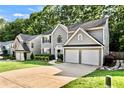 Attractive two-story home featuring gray siding, two-car garage, front yard, and professional landscaping at 4311 Sentinel Nw Pl, Kennesaw, GA 30144