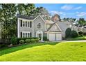 Well-manicured front yard of a two-story home with a two-car garage and driveway at 4311 Sentinel Nw Pl, Kennesaw, GA 30144