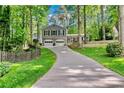 Traditional home with a long driveway, two-car garage, covered front porch, and mature trees at 4330 Volnay Ne Ct, Marietta, GA 30066