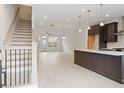 Open-concept living space featuring hardwood floors, staircase, and kitchen with a center island at 1309 Bennett Creek Ovlk, Suwanee, GA 30024