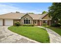 Attractive one-story home with stone and brick details, a circular driveway, and well-maintained landscaping at 2139 Bramlett Nw Pl, Marietta, GA 30064