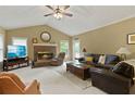 Cozy living room featuring a brick fireplace, plush seating, and a vaulted ceiling with a ceiling fan at 2139 Bramlett Nw Pl, Marietta, GA 30064