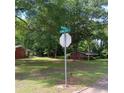 Magnolia and Johnson street sign; build in a neighborhood with lush mature trees and southern charm at 2637 Johnson St, Lithonia, GA 30058