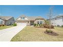 Inviting single-Gathering home featuring stone accents, a two-car garage, and a well-manicured lawn at 3715 Bridges Ct, Cumming, GA 30040