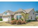 Beautiful single-Gathering home with stone and siding accents, green lawn, and manicured landscaping at 3715 Bridges Ct, Cumming, GA 30040
