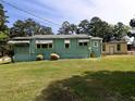 Backyard of a single-Gathering home with a detached garage, green grass, and lots of space at 6296 Longino Drive, Union City, GA 30291