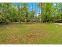Spacious front yard with mature trees offering shade and privacy with a view of the house at 7370 N Mitchell Ct, Villa Rica, GA 30180