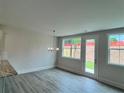 Bright dining area with modern chandelier and access to the backyard at 1058 Crest Mill Dr, Marietta, GA 30008