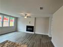Spacious living room features a sleek fireplace, ceiling fan, and large windows at 1058 Crest Mill Dr, Marietta, GA 30008
