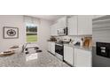Modern kitchen featuring stainless steel appliances, granite countertops, and ample cabinet space at 358 Friendship Oak Way, Hampton, GA 30228