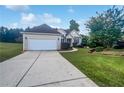 Charming single-story home with a well-manicured lawn, two-car garage, and inviting front entrance at 4335 Northwind Dr, Ellenwood, GA 30294