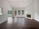 Bright living room with fireplace, hardwood floors, and large windows bringing in natural light at 4335 Northwind Dr, Ellenwood, GA 30294