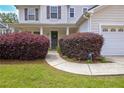 Close-up of a charming front entrance with manicured bushes and a walkway to the front door at 2951 Edgewater St, South Fulton, GA 30331