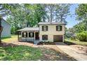 Charming two-story home featuring a covered front porch and a built-in garage at 3959 Wood Path Dr, Stone Mountain, GA 30083
