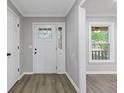 Clean entryway with gray walls, vinyl floors, and white trim, featuring a window and a white front door at 798 Brownlee Ln, Lawrenceville, GA 30044