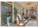 Inviting front porch with rocking chairs, ceiling fans, and relaxing decor creating a cozy outdoor space at 3213 Blackley Old Rd, Douglasville, GA 30135
