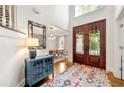Grand foyer featuring a high ceiling, decorative rug, and stained-glass double doors at 3714 Westbrooke Ne Cir, Brookhaven, GA 30319