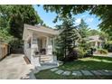 Inviting front exterior with a brick facade, covered porch, and mature trees offering shade and curb appeal at 614 Cooledge Ne Ave, Atlanta, GA 30306