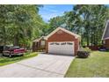 Charming brick home with a two-car garage and a well-maintained front yard and a red pickup truck at 6718 Oakhurst Ct, Douglasville, GA 30134