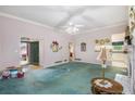 Spacious living room with a decorative fireplace and large window and ceiling fan at 6718 Oakhurst Ct, Douglasville, GA 30134