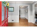 Inviting entryway featuring hardwood floors, wainscoting, and a view into other rooms at 1172 Malvern Hunt Ct, Lawrenceville, GA 30043