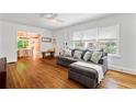 Inviting living room featuring hardwood floors, large windows, and a comfortable gray sectional sofa at 131 Lively St, Norcross, GA 30071
