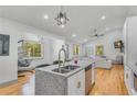 Modern kitchen with granite countertops, stainless steel appliances, and an open concept design flowing into the living area at 1497 Eason Nw St, Atlanta, GA 30314