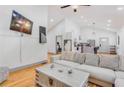 Bright living room with hardwood floors, a vaulted ceiling, and an open floor plan that leads to the kitchen at 1497 Eason Nw St, Atlanta, GA 30314
