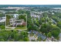 Aerial view of neighborhood with a picture of the home over it and trees surrounding the properties at 2100 Rockies Ct, Norcross, GA 30071