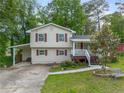 Two story home featuring neutral siding, red shutters and a well maintained lawn at 2100 Rockies Ct, Norcross, GA 30071