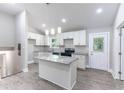 Modern kitchen featuring an island, granite countertops, pendant lights, and new stainless steel appliances at 3017 Tribble Ln, Atlanta, GA 30311