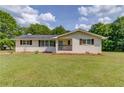 Charming brick home featuring a well-maintained lawn and inviting front porch at 3600 Anglin Rd, Loganville, GA 30052