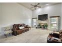 Spacious living room featuring a cozy fireplace, large TV, and comfortable seating, ideal for relaxing and entertaining at 4180 Mount Paran Dr, Social Circle, GA 30025