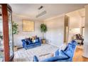 Cozy sitting area with plush blue seating, decorative plants, and a stylish chandelier, perfect for intimate gatherings at 4180 Mount Paran Dr, Social Circle, GA 30025