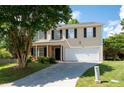 Two story home with black shutters, light siding, and well manicured lawn and front yard at 45 Waterloo Ct, Hiram, GA 30141