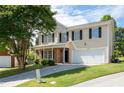 Two-story home with light yellow siding, black shutters, an attached two-car garage, and a well-manicured lawn at 45 Waterloo Ct, Hiram, GA 30141