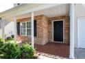 Inviting front porch with stone accents, tiled flooring, and elegant white columns at 45 Waterloo Ct, Hiram, GA 30141