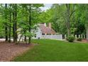 Spacious backyard featuring a well-manicured lawn and a privacy fence, backed by mature trees at 400 N Peachtree Pkwy, Peachtree City, GA 30269