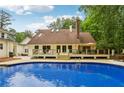 Inviting backyard pool with a spacious deck, perfect for outdoor relaxation and entertaining at 400 N Peachtree Pkwy, Peachtree City, GA 30269