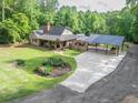 Expansive aerial view featuring a well-maintained lawn, a charming home, and a convenient carport at 814 Clarke Trl, Dacula, GA 30019