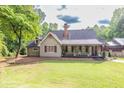 Charming home with a cozy front porch and well-manicured lawn perfect for relaxation at 814 Clarke Trl, Dacula, GA 30019